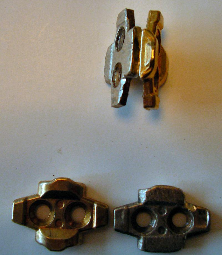 The silver-coloured cleats are old and due for replacement while the brass coloured ones are brand new. Compare the shapes of the two sets. They should be identical but the material has gradually been worn away.
